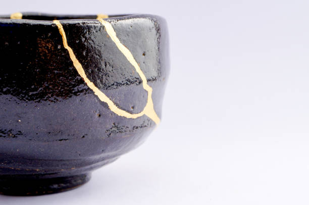 istock Antique broken Japanese black bowl repaired with gold kintsugi technique 1280390209