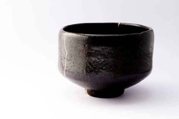 istock Antique broken Japanese black bowl repaired with gold kintsugi technique 1280390227