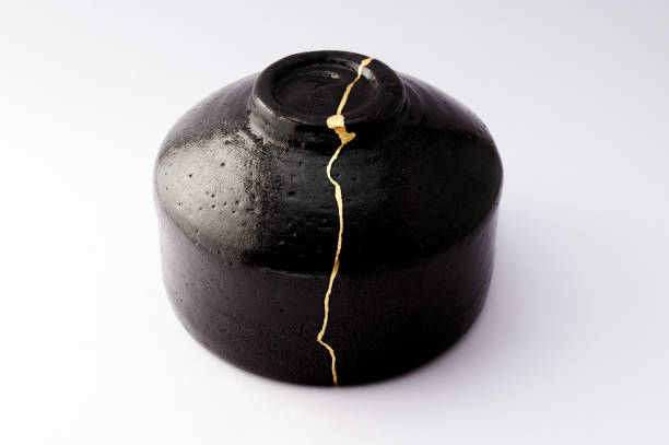 istock Antique broken Japanese black bowl repaired with gold kintsugi technique 1280390234