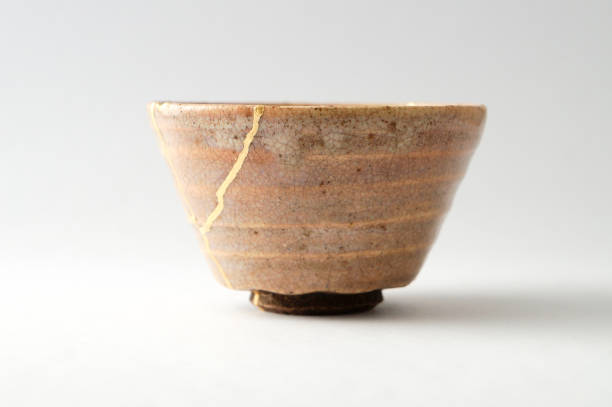 istock Antique broken Japanese cup repaired with gold kintsugi technique 1280390312