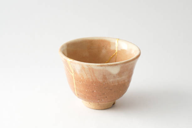 istock Antique broken Japanese cup repaired with gold kintsugi technique 1280390320
