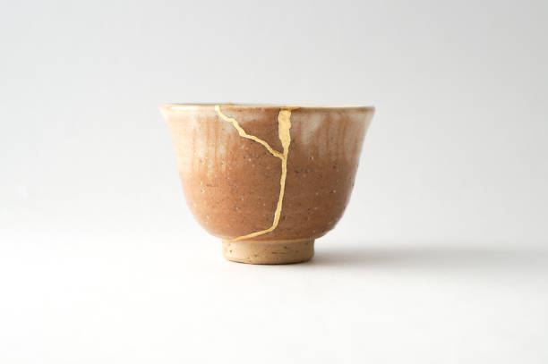 istock Antique broken Japanese cup repaired with gold kintsugi technique 1280390332