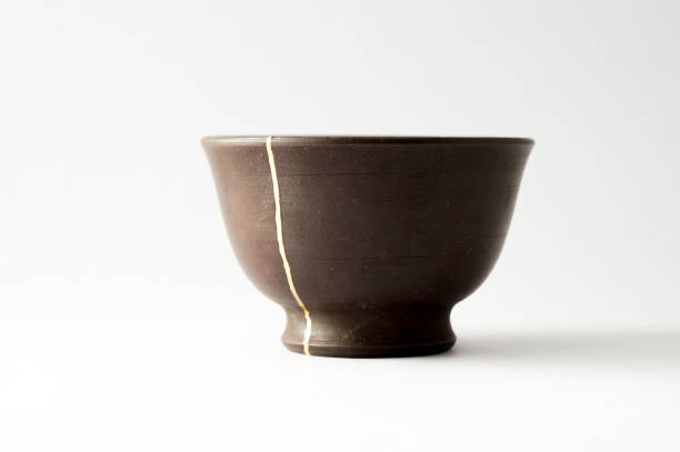 istock Antique broken Japanese cup repaired with gold kintsugi technique 1280390335