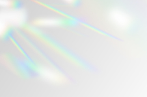 Vector illustration of rainbow flare overlay effect mockup. Blurred reflection crystal rays, shadows and flash on background. Natural iridescent light backdrop.