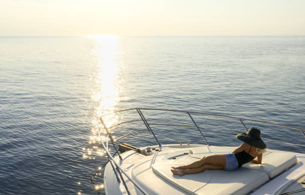 istock Woman relaxing on yacht bow at sunset. 1280395178