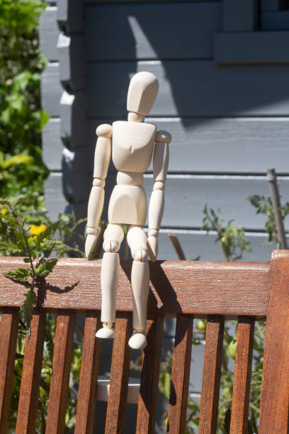 istock Mannequin for drawing sitting on a chair 1280396321