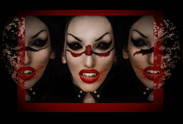 Horizontal colour studio shot on blue of vampire couple closeup. Both in profile with mouths open in snarls, embracing.