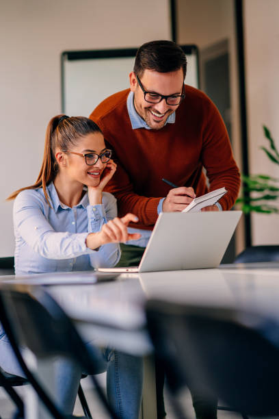 istock Businesswoman helping her colleague to write down the notes 1280398100