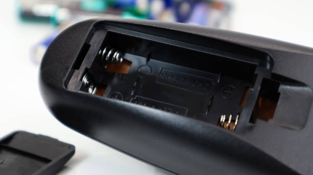 istock Remote control amid scattered disposable AAA and AA alkaline batteries. Battery replacement, spare parts. An empty battery compartment of the remote control close-up. Recycling concept 1280398510