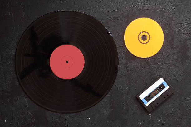 istock Vinyl record, cd, audio and video cassettes top view 1280399739
