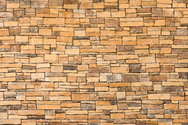 istock background and texture of yellow decorative stone wall surface. 1280400624