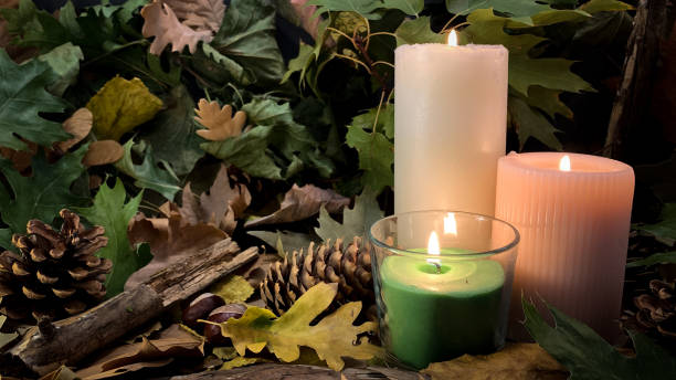 istock Burning candles, autumn leaves and pine cones background 1280401012