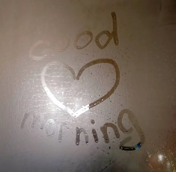 inscription good morning on the sweaty foggy bathroom mirror