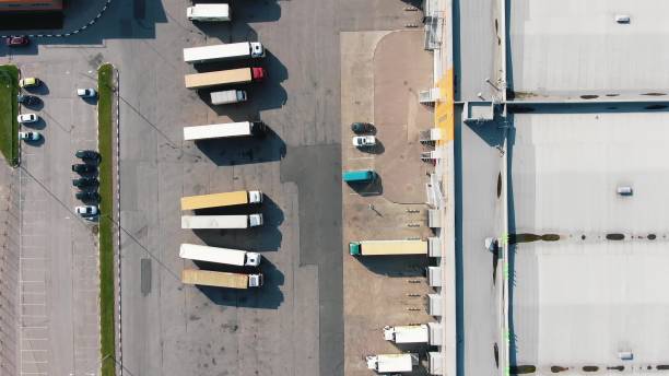 istock Different trucks on parking site near huge warehouse aerial 1280402740