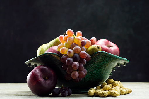 Fruit bowl with fruit on a wooden table