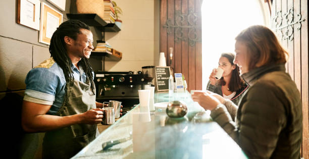 istock Barista talking to customers in a bistro 1280403009