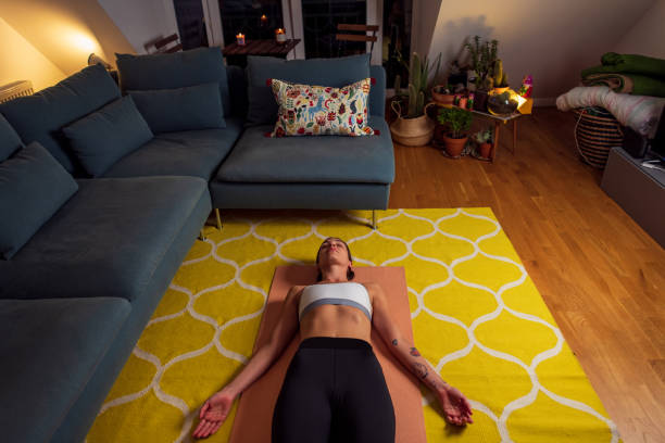 istock Young woman practicing yoga at home 1280403927