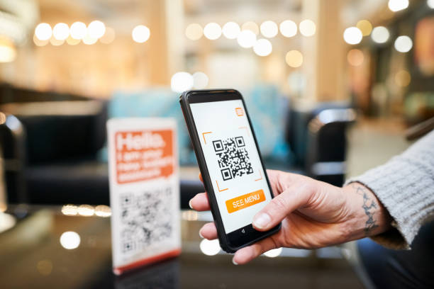 Cashless digital wallet payment Close-up of hand of a woman scanning the qr code with her phone to make a cashless payment in a cafe mobile payment photos stock pictures, royalty-free photos & images