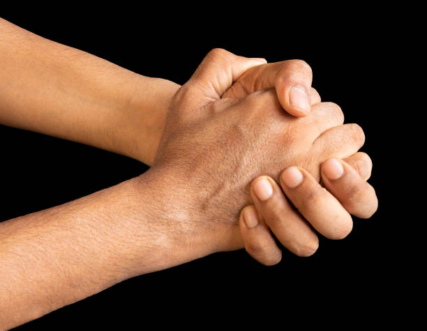 istock Pair of hands clutched and held together 1280404377