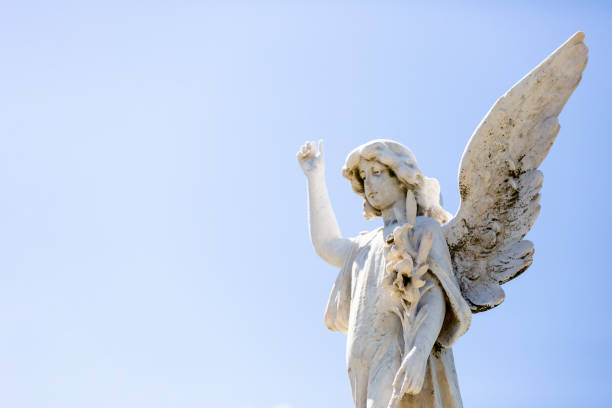 istock Angel, old statue of angle, light blue sky background with copy space 1280404905