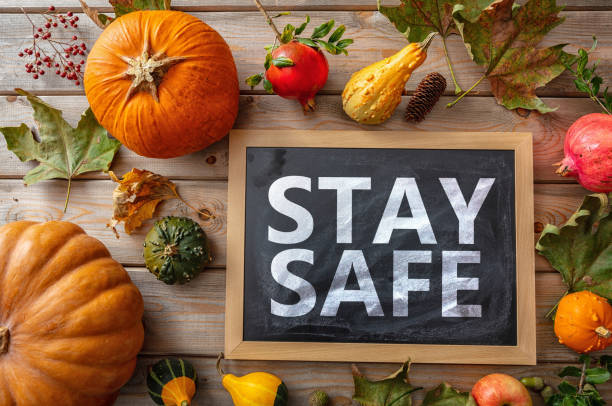 Stay safe message and thanksgiving pumpkins against wooden background. COVID 19 days Thanksgiving COVID 19 days. STAY SAFE message and thanksgiving flatlay on wooden background. Coronavirus protection thanksgiving holiday covid stock pictures, royalty-free photos & images