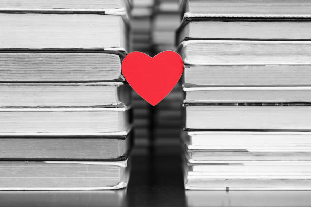 istock A red heart hangs between the stacks of books in the library. 1280407534