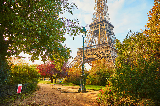 Scenic view of the Eiffel tower and Champ de Mars park on a beautiful and colorful autumn day