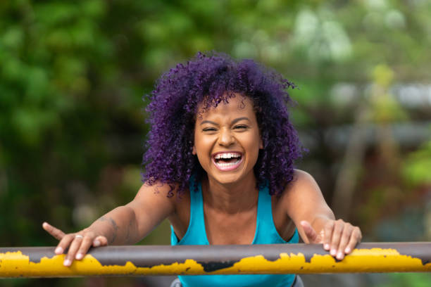 Smiling young afro woman outdoors Young woman, Purple hair, Exercises, Sport, Smiling purple hair stock pictures, royalty-free photos & images
