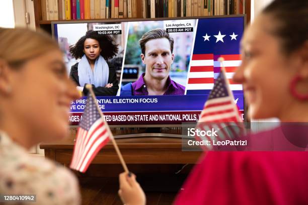 Women Friends Celebrating Election Results In Front Of Tv Stock Photo - Download Image Now