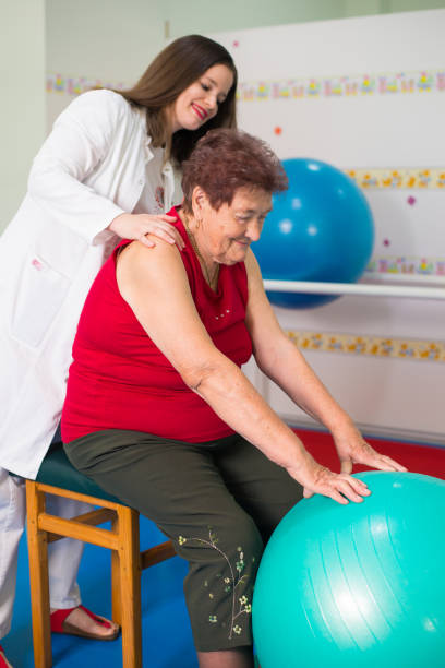 istock Old woman on physical therapy 1280411231
