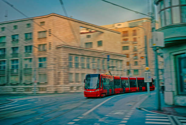 View of a moving modern tram in motion blur. View of a moving modern tram in motion blur. Tram moving on a street of Bratislava. blurred motion street car green stock pictures, royalty-free photos & images