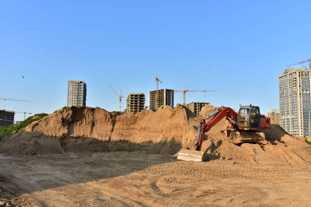 istock Bucket wheel excavator on earthmoving at construction site. Backhoe digs sand on blue sky background 1280413183