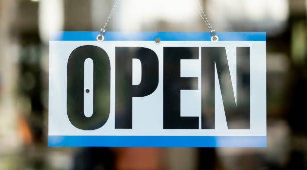 istock Open Business sign hanging inside store 1280415834
