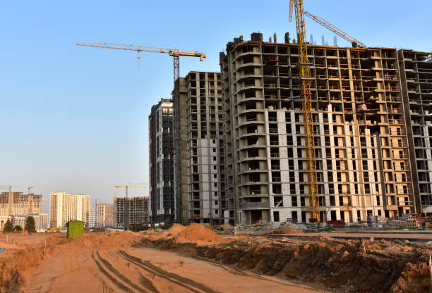 istock Tower cranes in action at construction site. Construction of skeleton of new modern residential buildings 1280416005