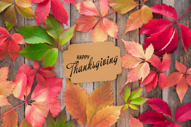 istock Colorful autumn leaves on rustic wooden background with text 1280416656