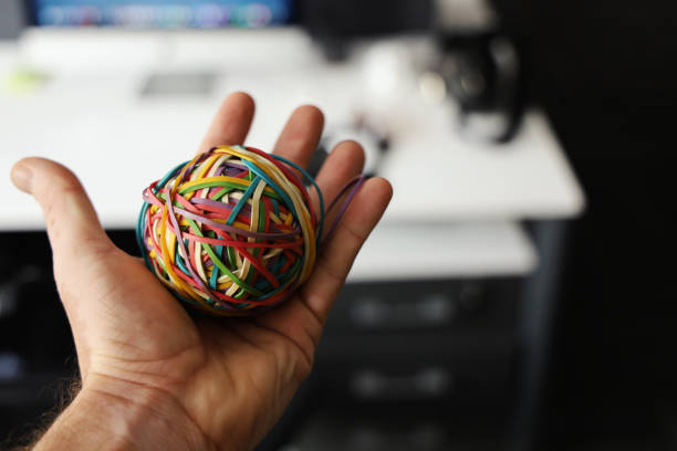 Man holding rubber band ball