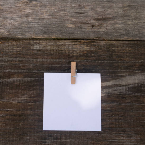 istock blank paper isolated on wooden background, copy space. 1280418302