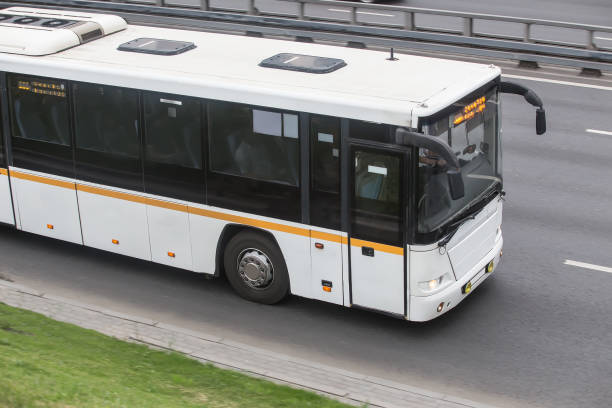 istock tourist bus is moving down the street 1280419938
