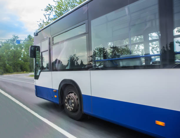 istock bus moves along the road 1280420024