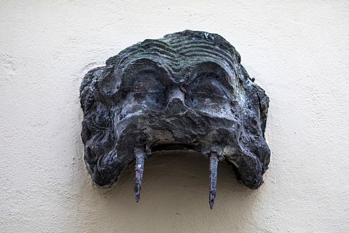 One of the ugly heads in the old town area of Cologne, or Koln, in Germany. In the Middle Ages, a post was pushed under the top jaw and a rope was thrown over the post to lower barrels into the cellar.