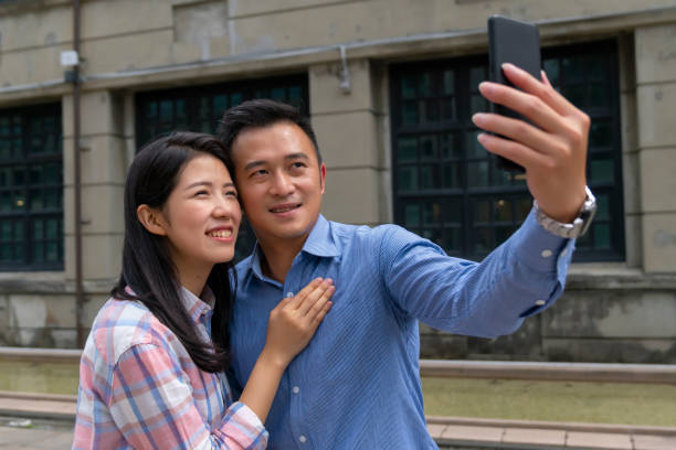 istock couple at the park taking selfie 1280424394