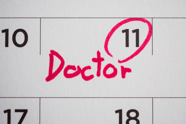 important doctor appointment schedule write on white calendar page date close up - today reminder note pad writing imagens e fotografias de stock