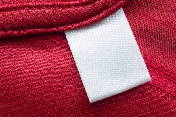 istock White blank laundry care clothes label on red polyester sport shirt background 1280425251
