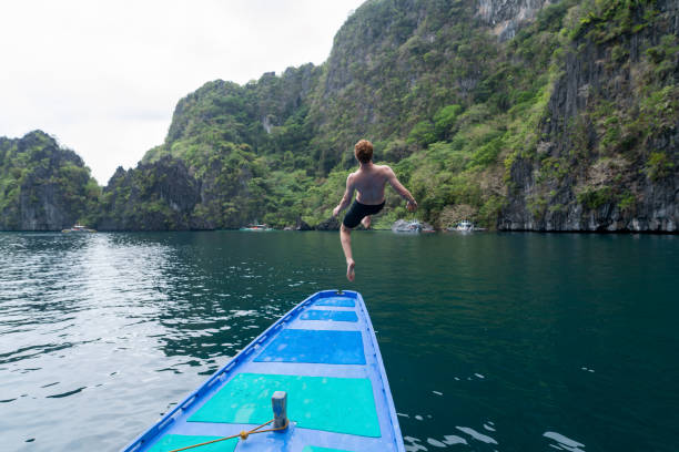 istock Man jumping off boat 1280425276