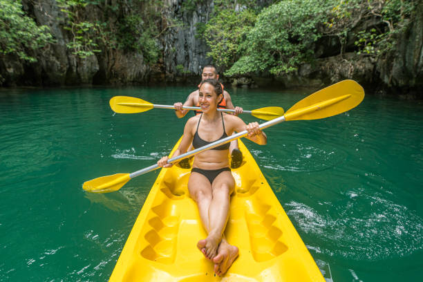 istock Mixed race couple kayaking on vacation 1280425288