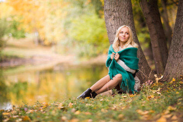 istock Beautiful blonde woman having fun in fall park outdoors. Copy Space. 1280431866