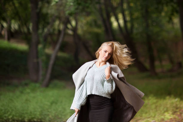 istock Beautiful blonde woman having fun in fall park outdoors. Copy Space. 1280431869