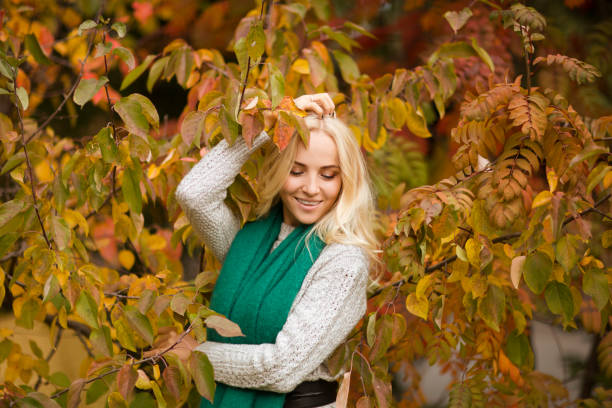 istock Beautiful blonde woman having fun in fall park outdoors. Copy Space. 1280431914