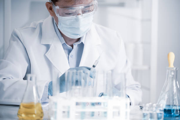 Asian male scientist working in a laboratory. Vaccine development concept. stock photo