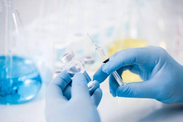 istock Hand of a scientist working in the laboratory. Vaccine development concept. 1280443274